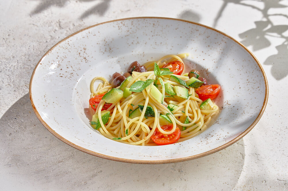 Spaghetti with zucchini, olives and cherry tomatoes
