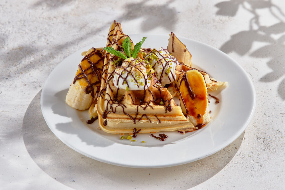 Belgian waffles with banana, chocolate and pistachios