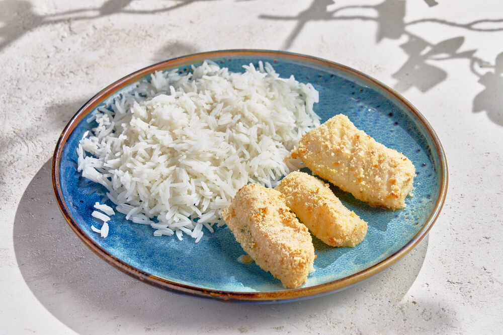 Baby sticks fish with rice