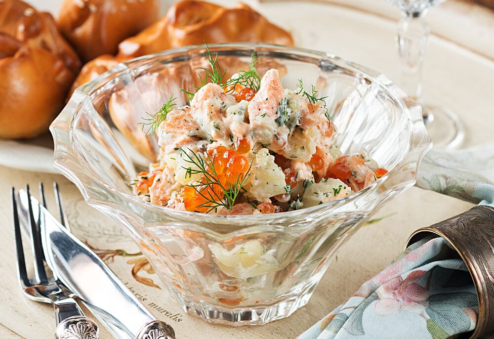 Salad of potatoes with smoked salmon, red caviar and sour cream