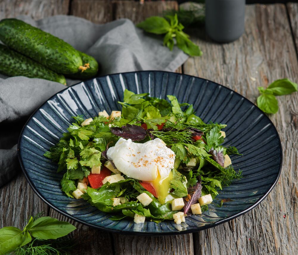 Salad with Baku vegetables and poached egg