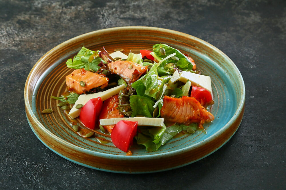 Warm salad with salmon and suluguni cheese