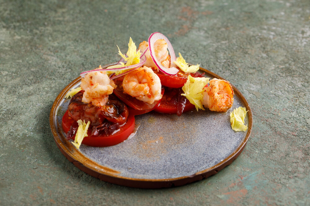 Two types of tomatoes with shrimps and sweet onions
