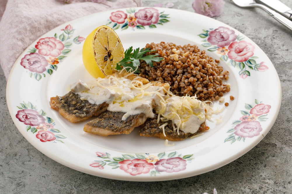 Carp fillet baked with sour cream served with buckwheat