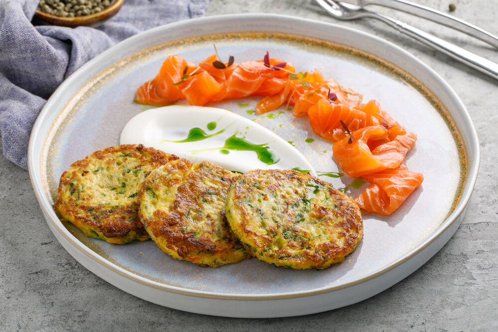 Homemade zucchini pancakes with chef-salted salmon