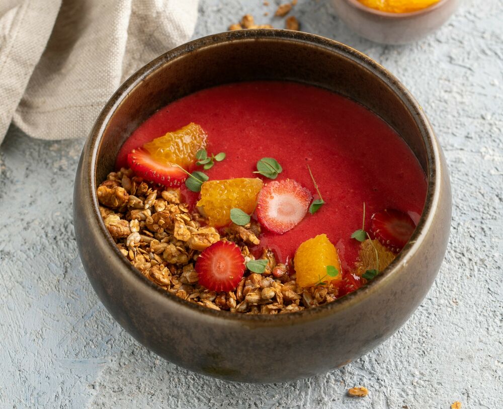 Homemade granola with a smoothie of raspberries