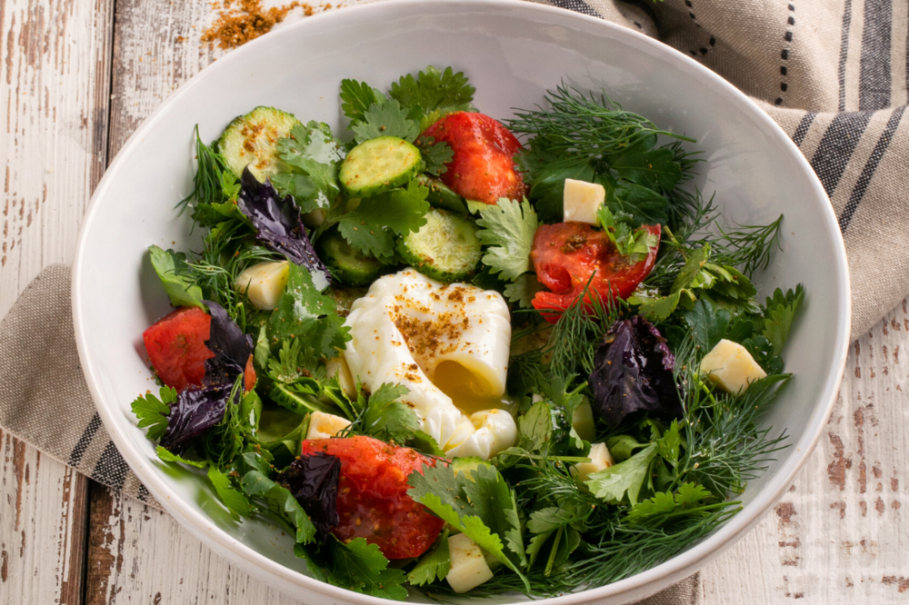 Salad with  vegetables and poached egg