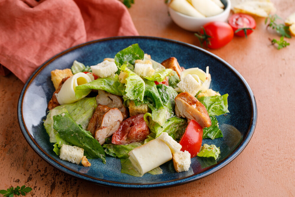 Warm salad with chicken and smoked suluguni cheese