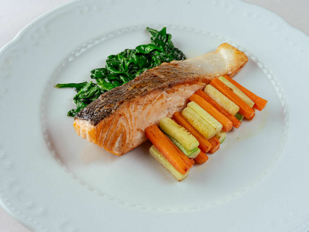 Salmon steak with vegetables and spinach