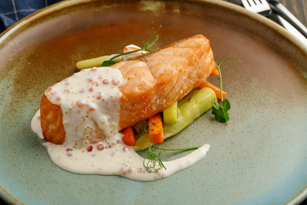 Salmon steak with vegetables and caviar sauce