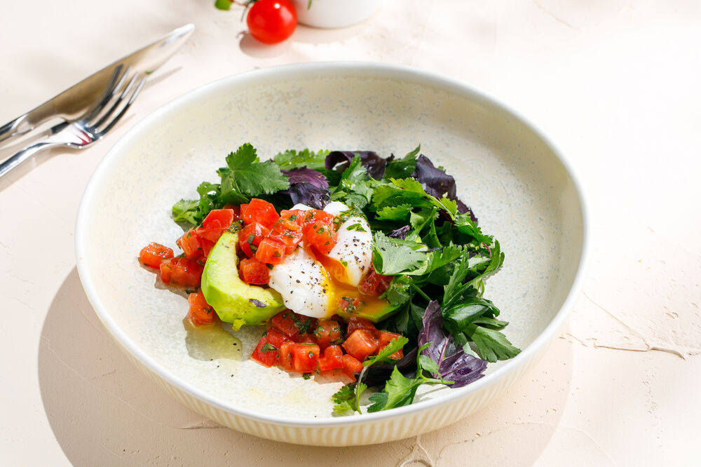 Baked avocado with tomato salsa and poached egg
