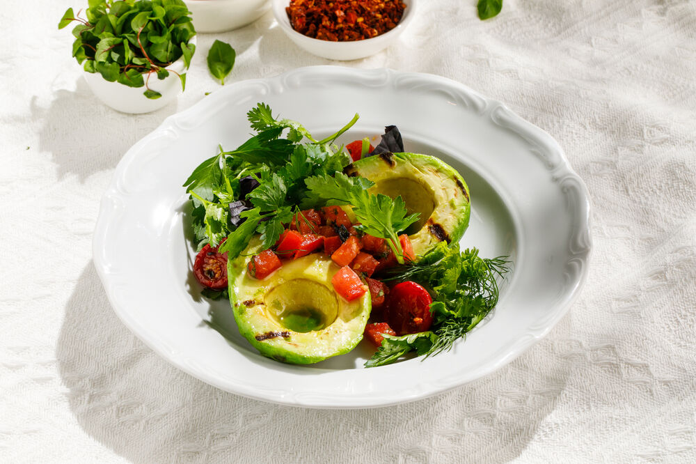 Baked avocado with tomato salsa and poached egg