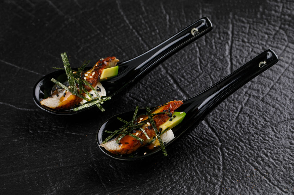  Canapes with eel, Unagi sauce, avocado and nori