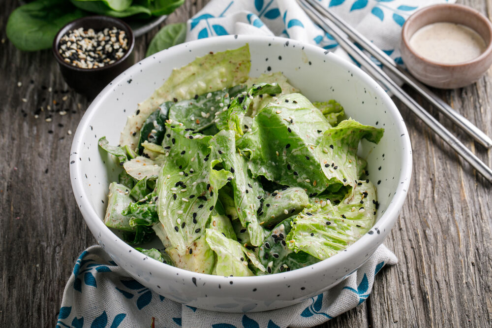 Green salad with avocado and sesame-nut sauce