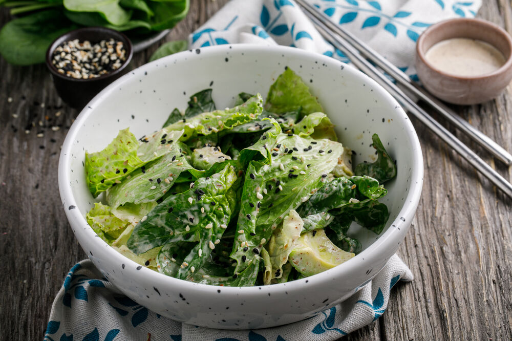 Green salad with avocado and sesame-nut dressing