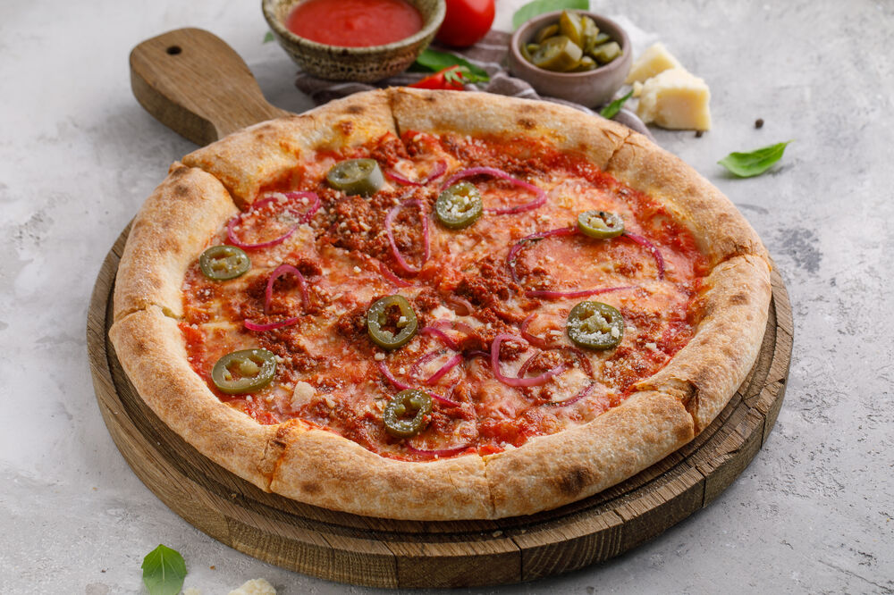 Pizza with anchovy, olives and jalapeno peppers