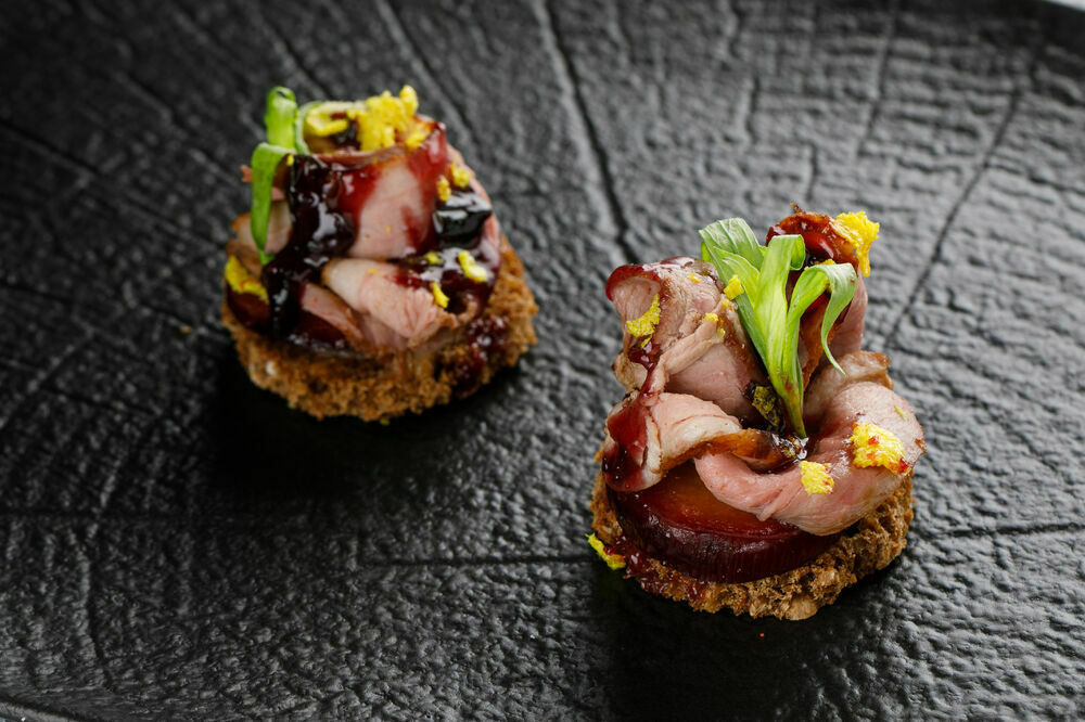 Canapes with smoked duck breast and Tkemali sauce