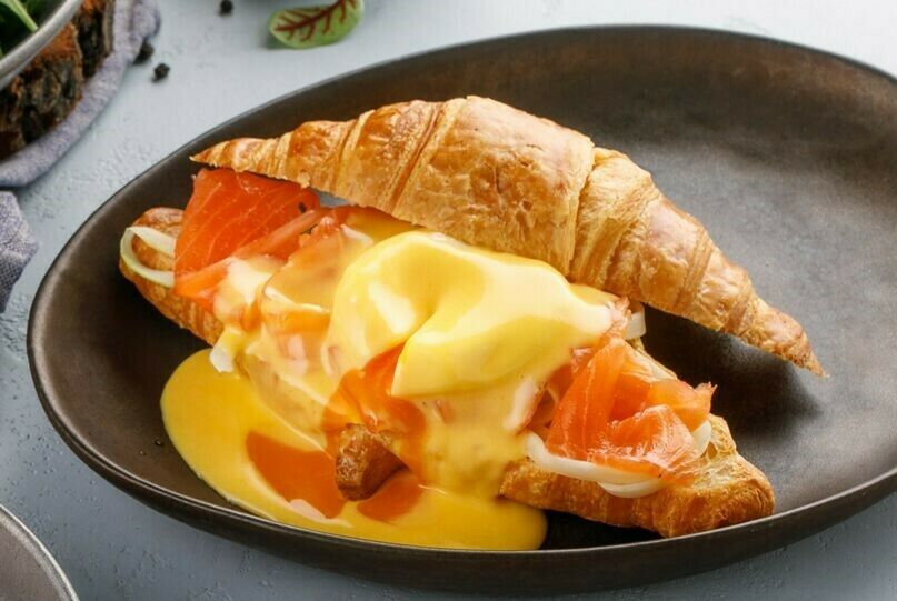 Croissant with salmon and egg benedict