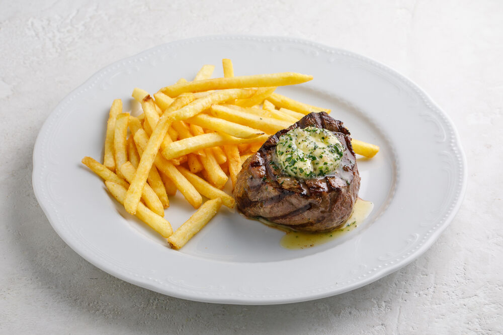 Beef steak with spicy butter and French fries
