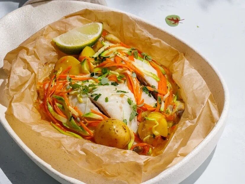 Dorado with vegetables. baked in parchment 