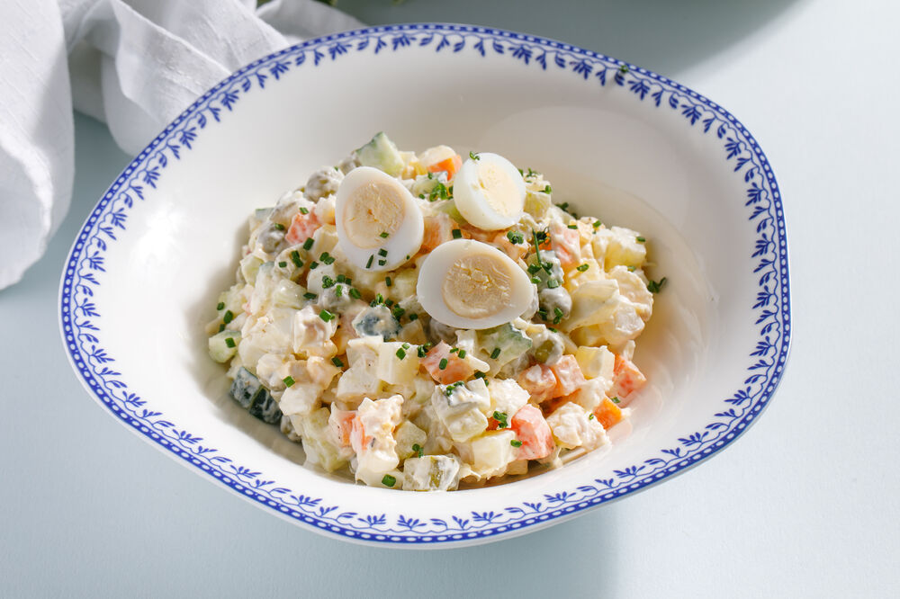 Olivier russian salad with smoked trout