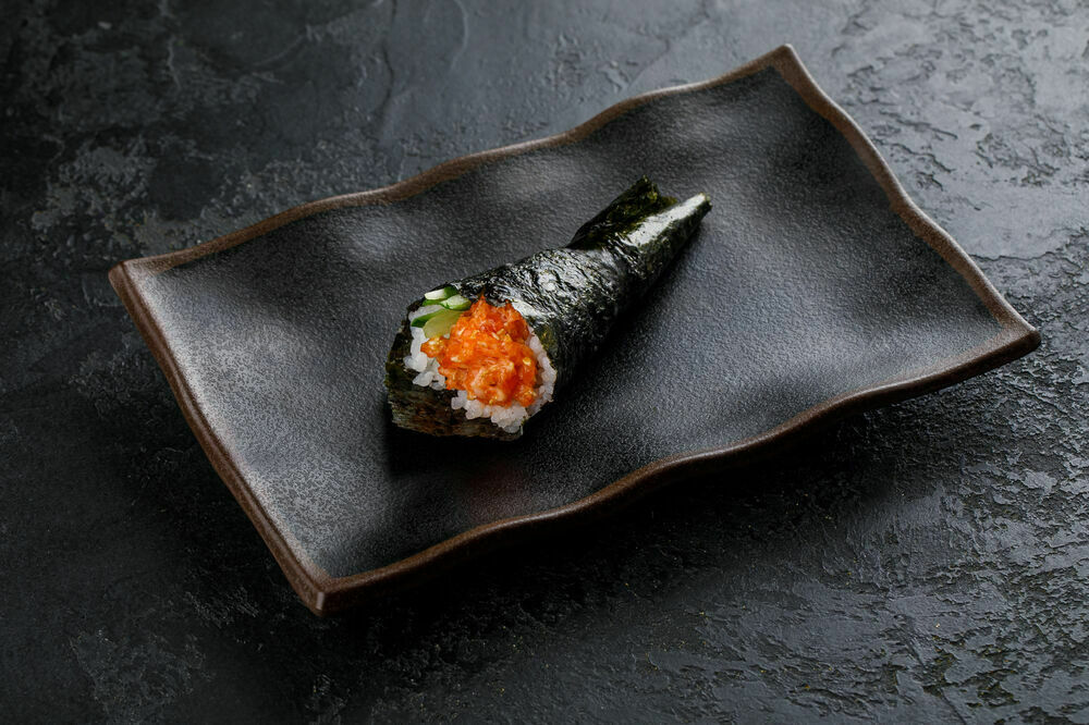 Spicy hand roll with avocado and salmon