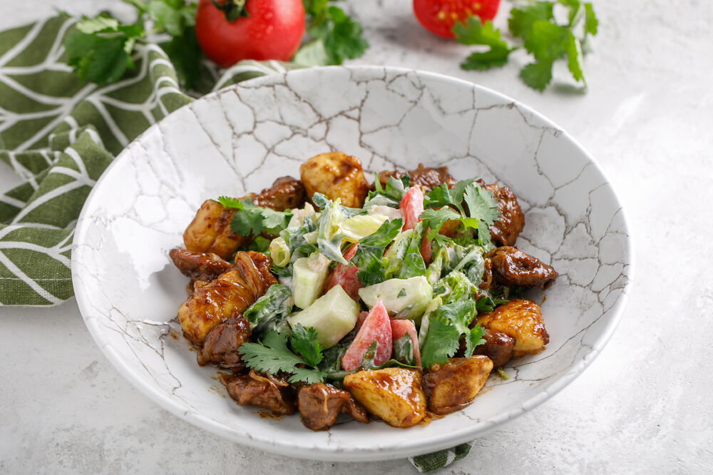 Salad with chicken fillet and liver with fresh vegetables