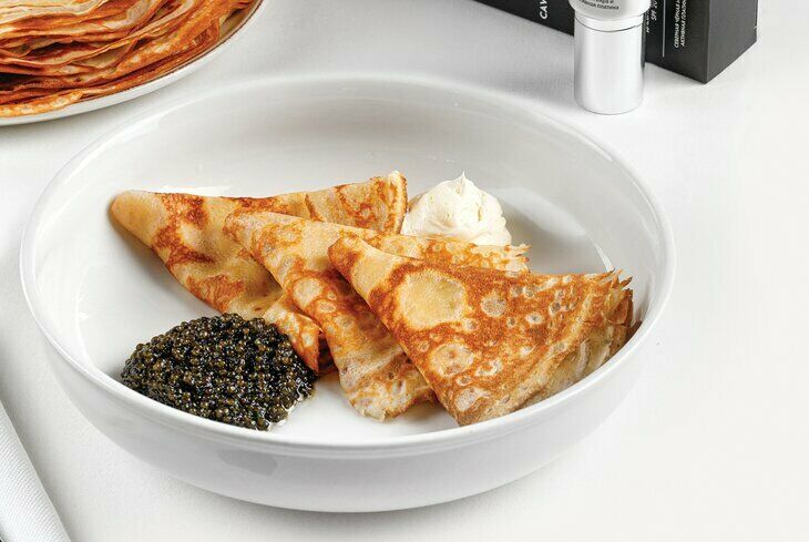 Pancakes with black caviar