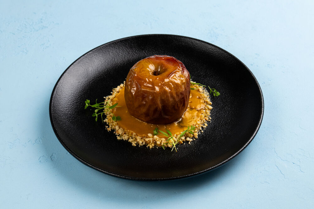 Baked apple with dried fruits and mango sauce