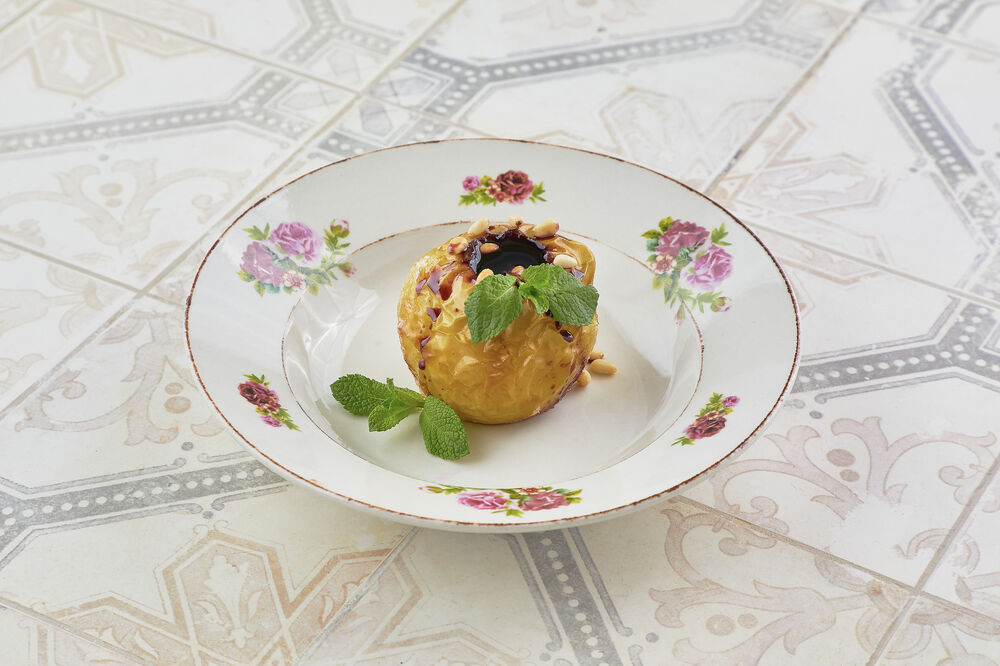 Baked apple with jam and nuts