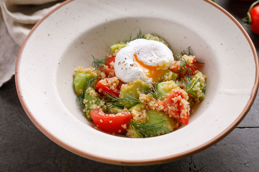 Salad with quinoa, avocado and poached eggs