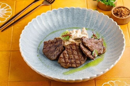 Beef medallions with mushrooms in a creamy sauce