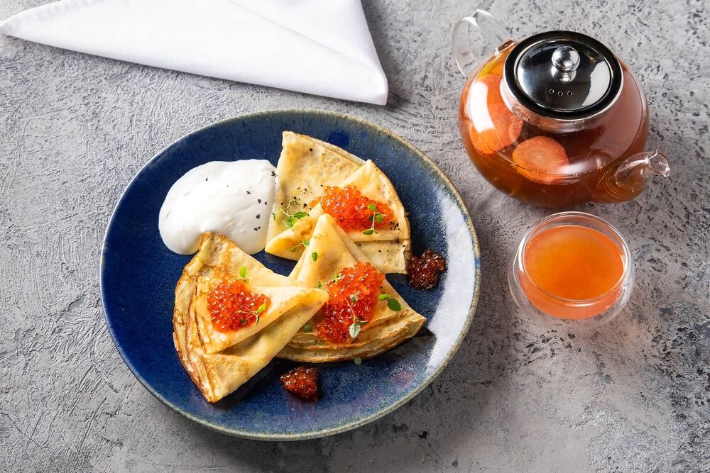Thin pancakes with red caviar