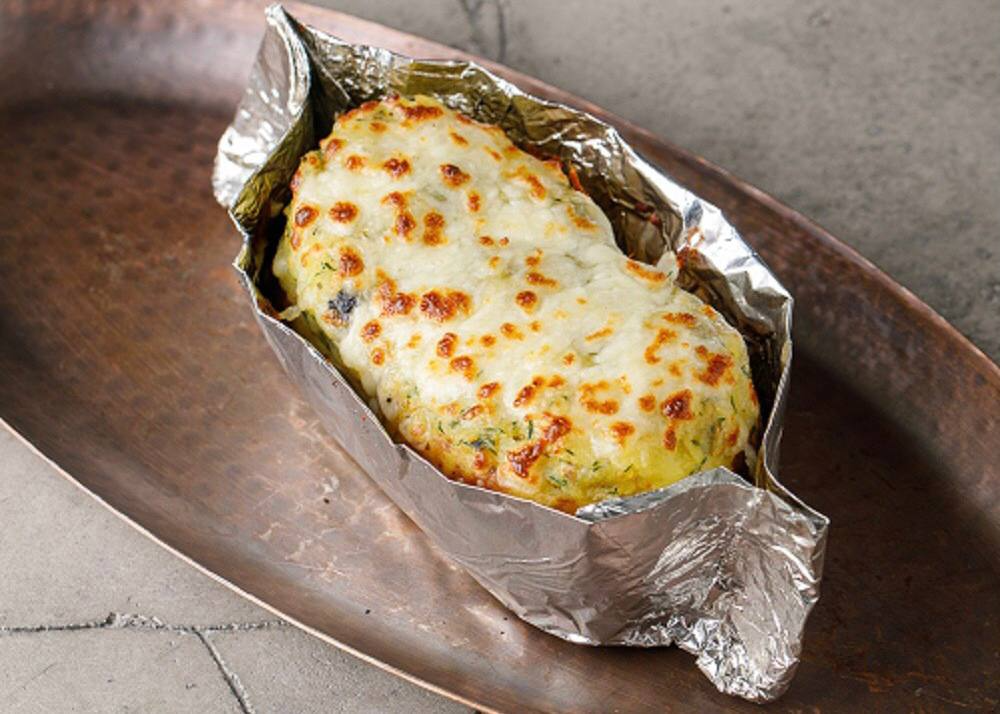 Potatoes baked in foil with garlic butter