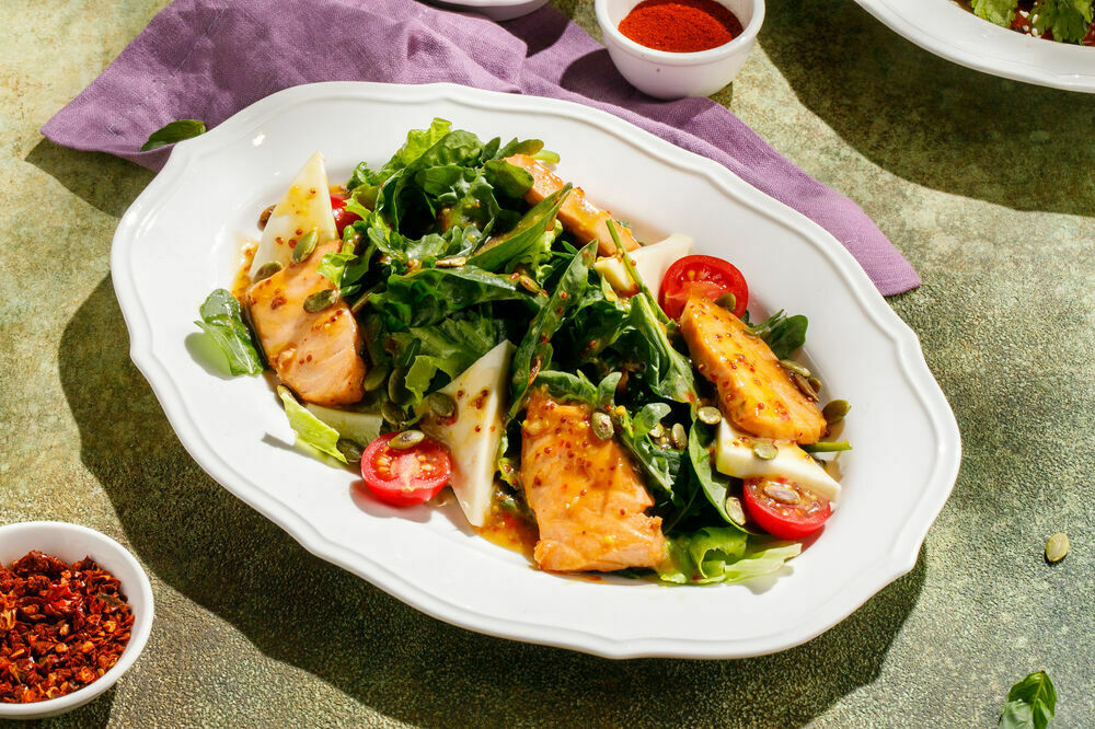 Warm salad with salmon and suluguni cheese