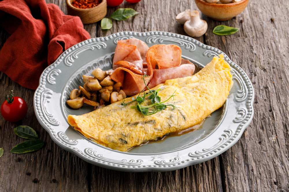 Omelet with cured tomatoes, cheese and ham.