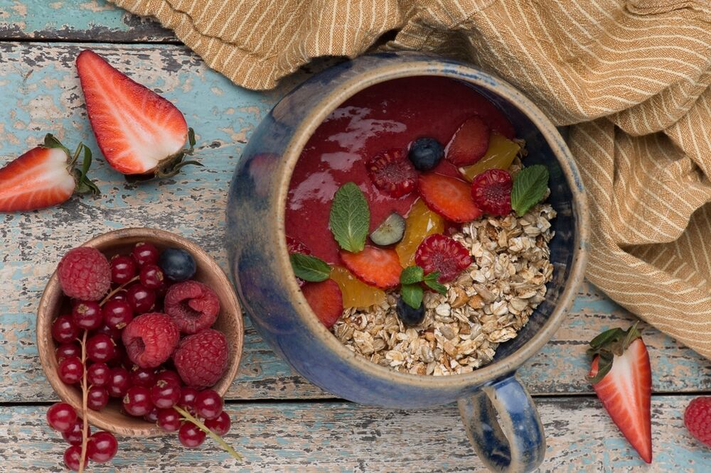 Granola with bright raspberry and strawberry smoothie
