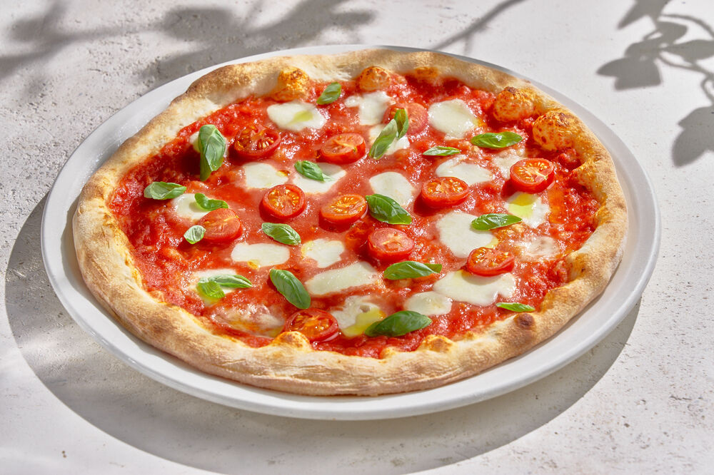 Pizza with Buffalo mozzarella, tomato sauce, cherry tomatoes