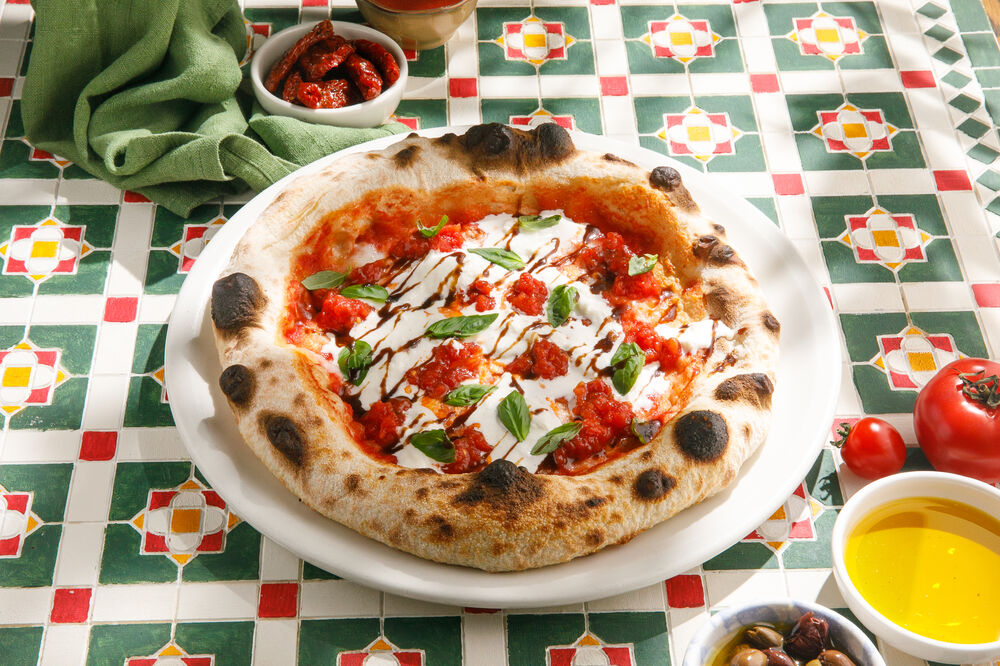 Pizza with Stracciatella, tomatoes and basil