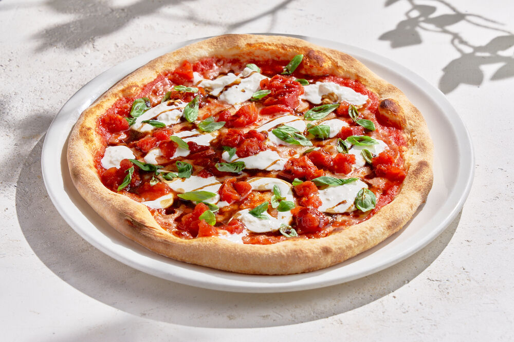 Pizza with Stracciatella, tomatoes and basil