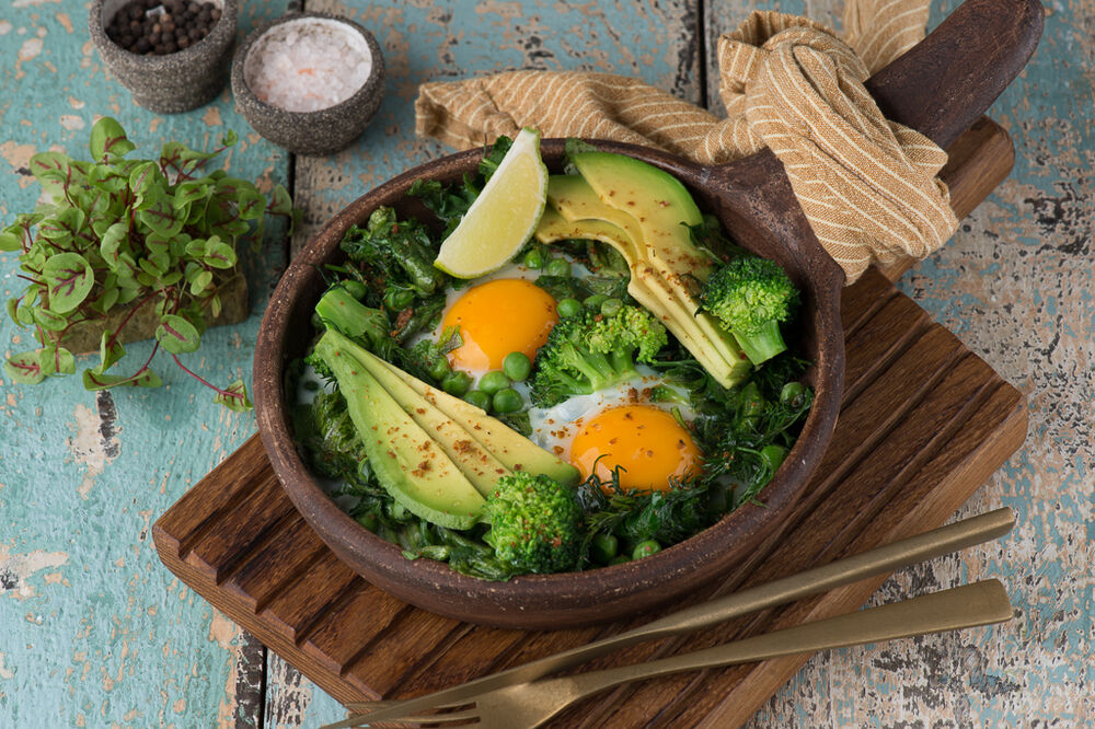 Fragrant fried eggs with herbs, avocado and spinach