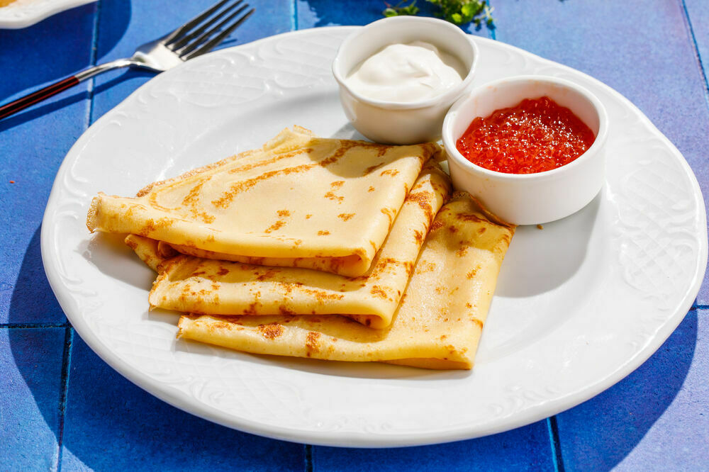 Pancakes with red caviar and sour cream