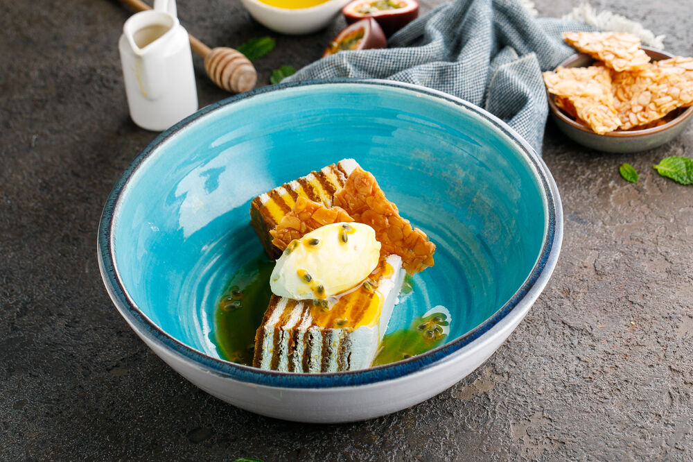 Honey cake with passion fruit sauce