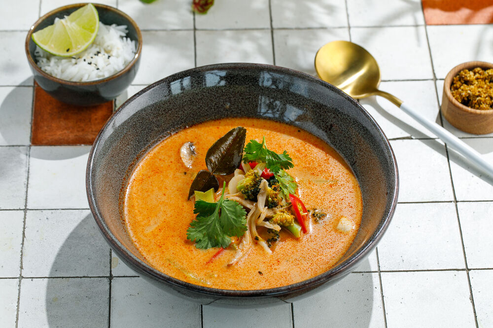 Tom yum on coconut milk with vegetables and champignons