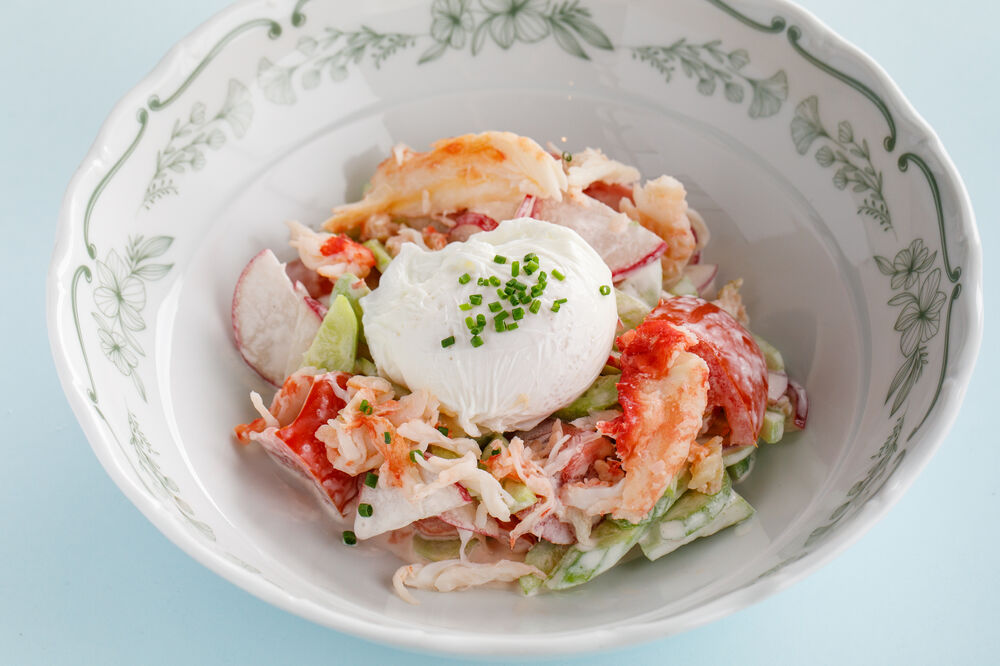 Vegetable salad with poached egg, sour cream and crab
