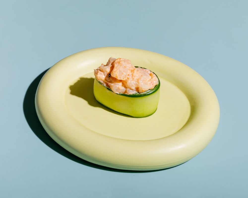 Sushi in cucumber with spicy scallop