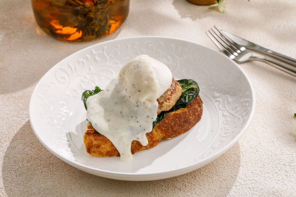Toast with poached eggs, turkey steak and truffle sauce