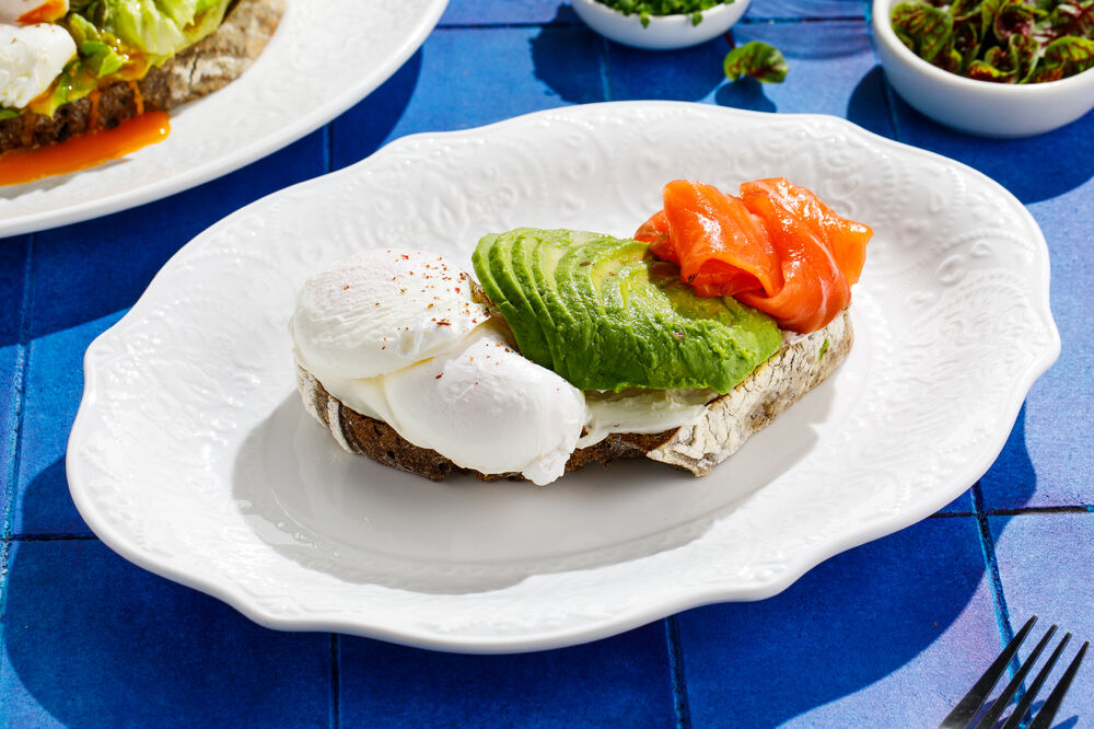 Poached egg on toast with salmon and avocado
