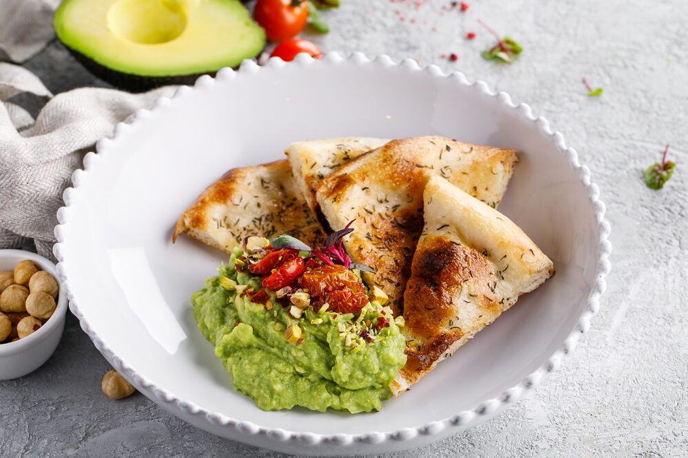 Guacamole with tomatoes and cheese bread