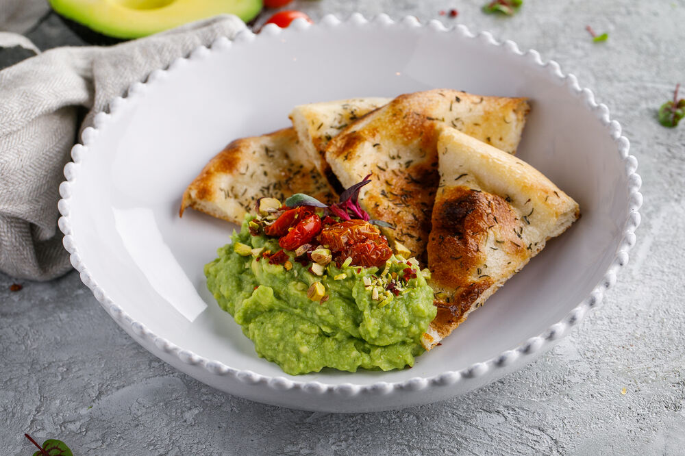 Guacamole with tomatoes and tortilla